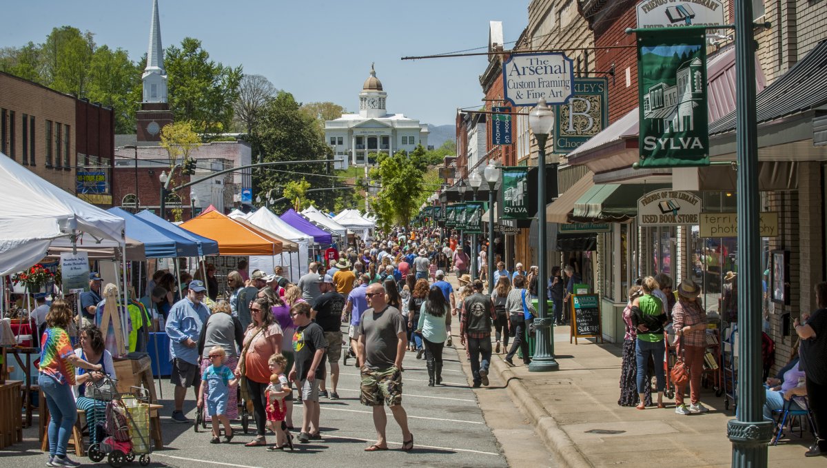 People attending festival in downtown Sylva during daytime.