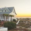 Oceanfront house with marsh and beach access to right at sunset in NC's Brunswick Islands.