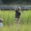 Two kids crabbing in marsh in NC's Brunswick Islands.