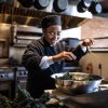 Chef in restaurant kitchen cooking collards