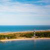 Aerial view of lighthouse and national seashore with water on both sides of land during daytime