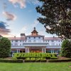 Exterior of beautiful Carolina Hotel with "Pinehurst 1895" designed into shrubbery in foreground.