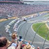 Coca-Cola 600 NASCAR race in Concord with stands filled with fans watching.