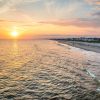 Sunset over beach at Oak Island with vacation rentals to the right