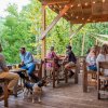 People enjoying beers on brewery outdoor patio during daytime.