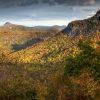 Bear-shaped shadow cast from mountains onto fall foliage below