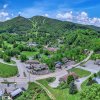 Aerial of mountain town in summer with roads, buildings and mountains