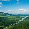 Aerial of Lake Lure surrounded by green forest and mountains from Chimney Rock.